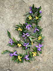 Maile style ti with mokara orchids